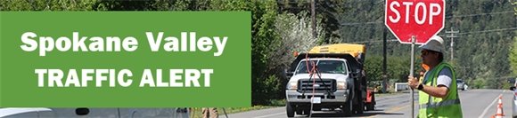 Traffic alert banner with construction flagger holding stop sign